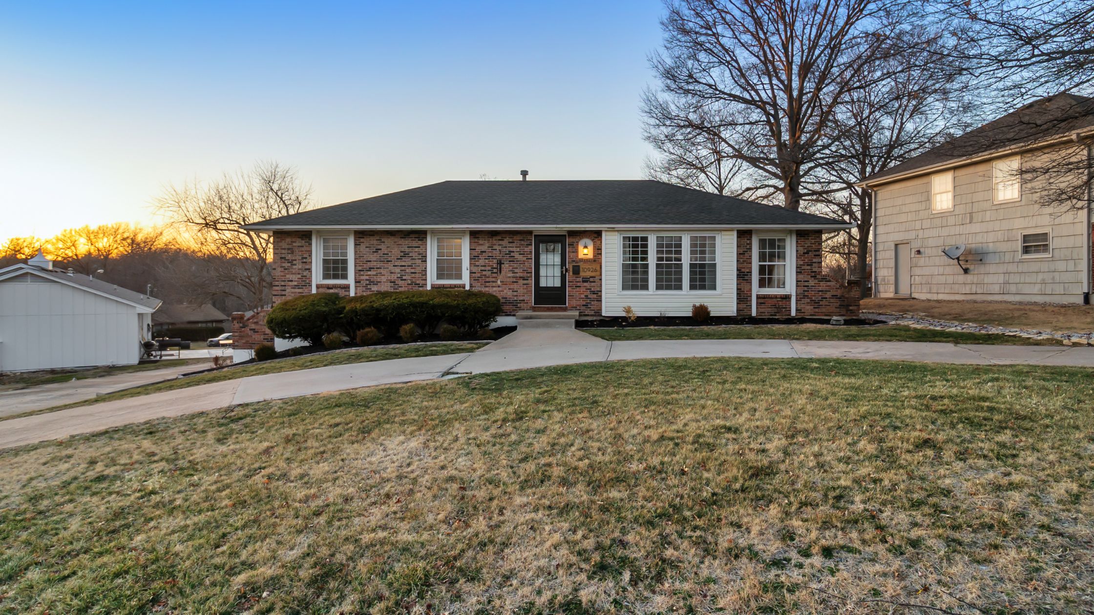 Raised ranch brick home with circle drive on large lot.