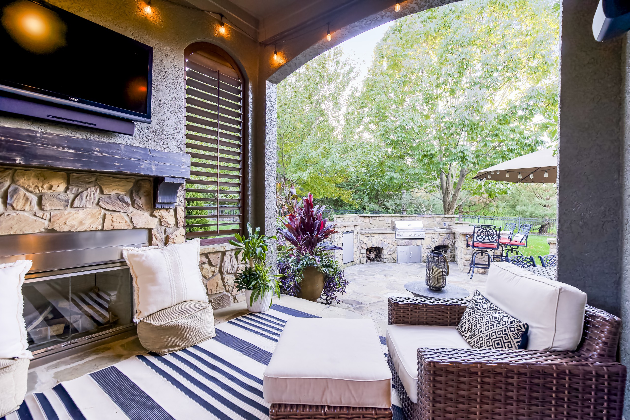 outdoor patio with television and furniture.