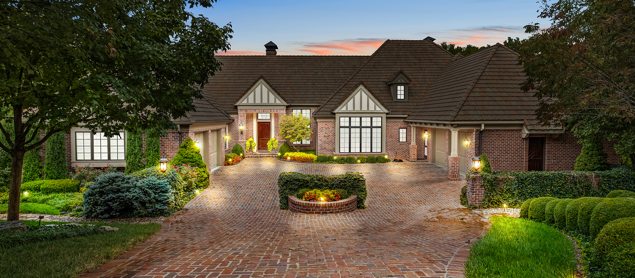 Red brick home with brick driveway