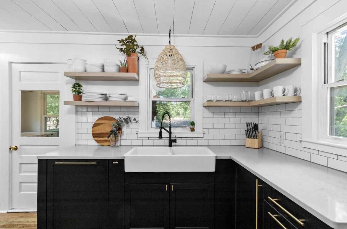  interior of a kitchen with white tile and dark cabinets