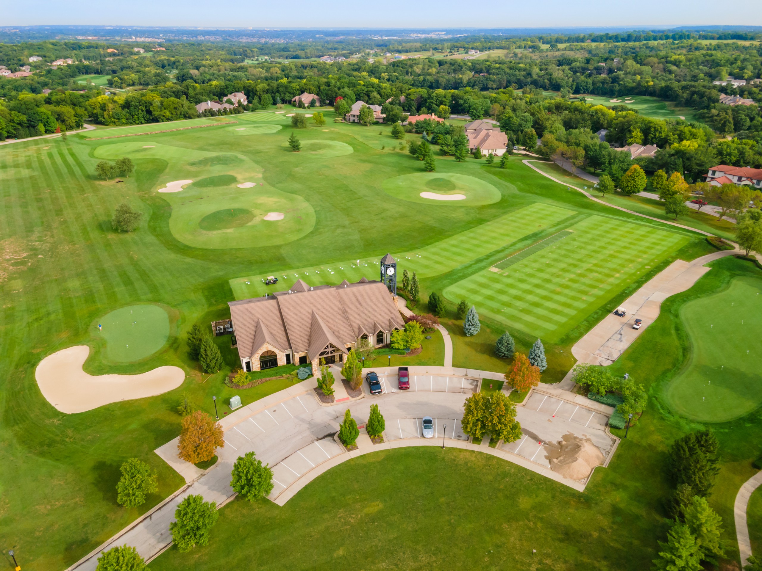 Aerial view of a golf course with home on it